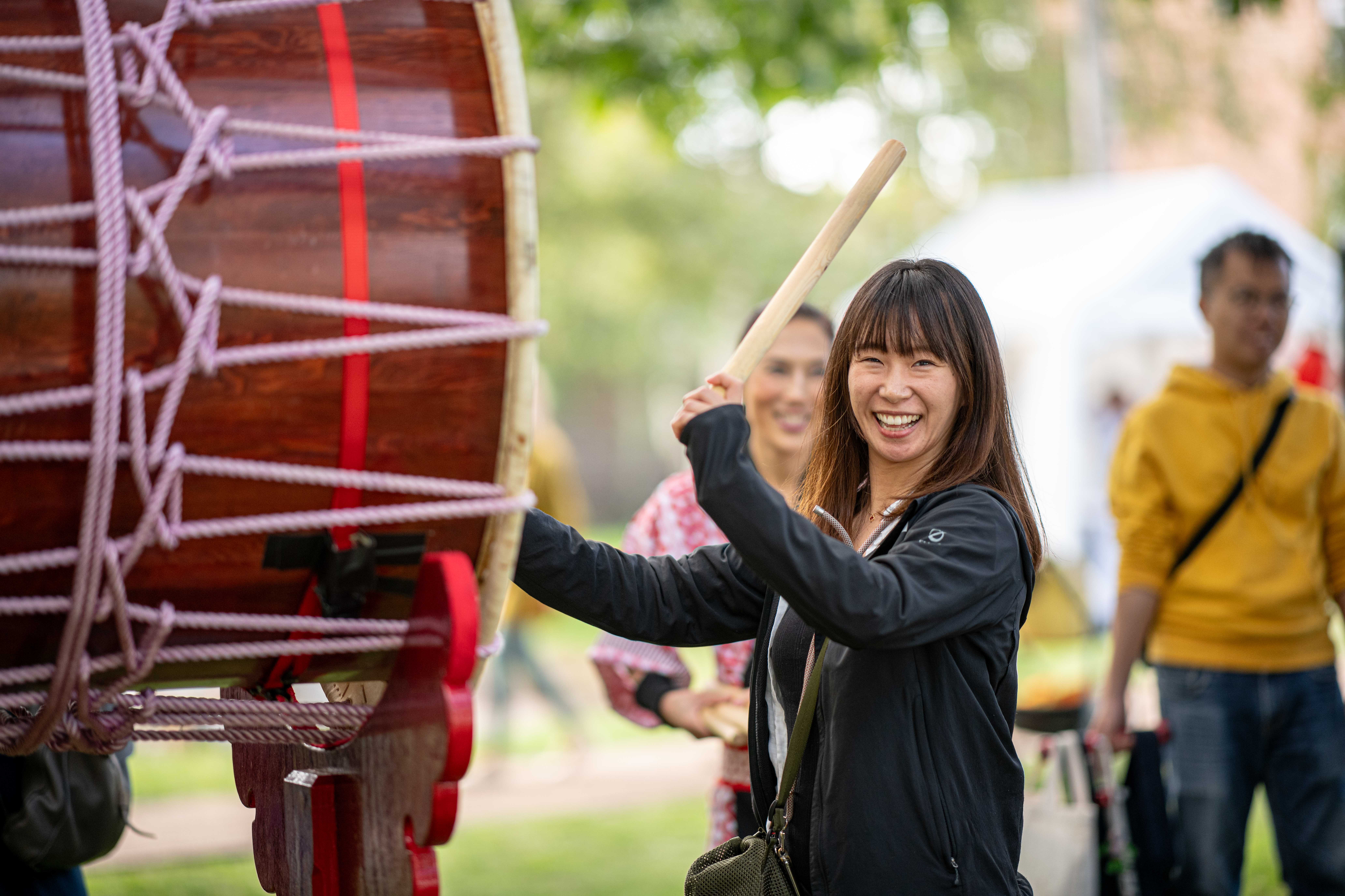 woman playing Japanese taiko drumming